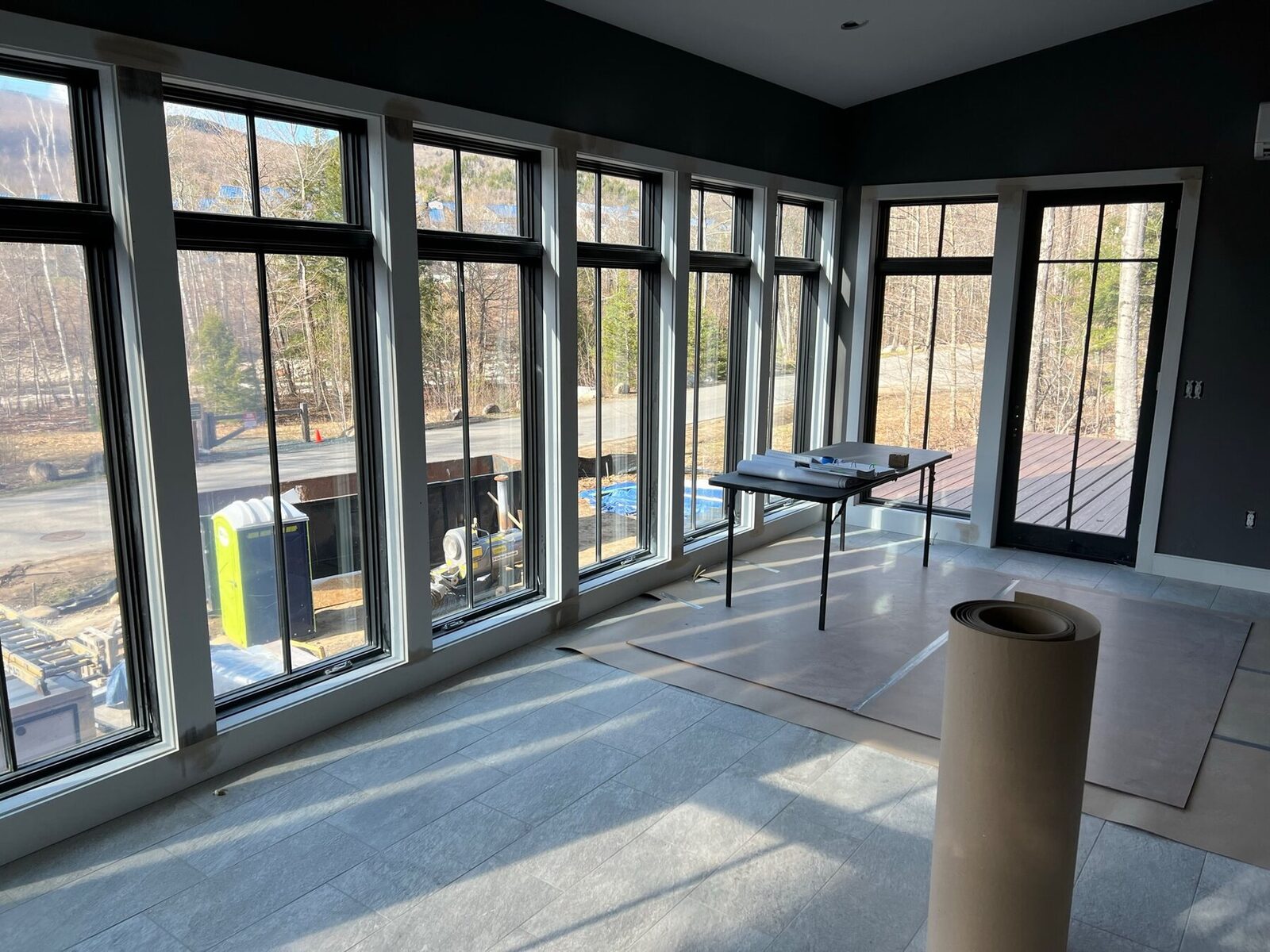 Sunroom wrapped in black framed windows with clean interior trim