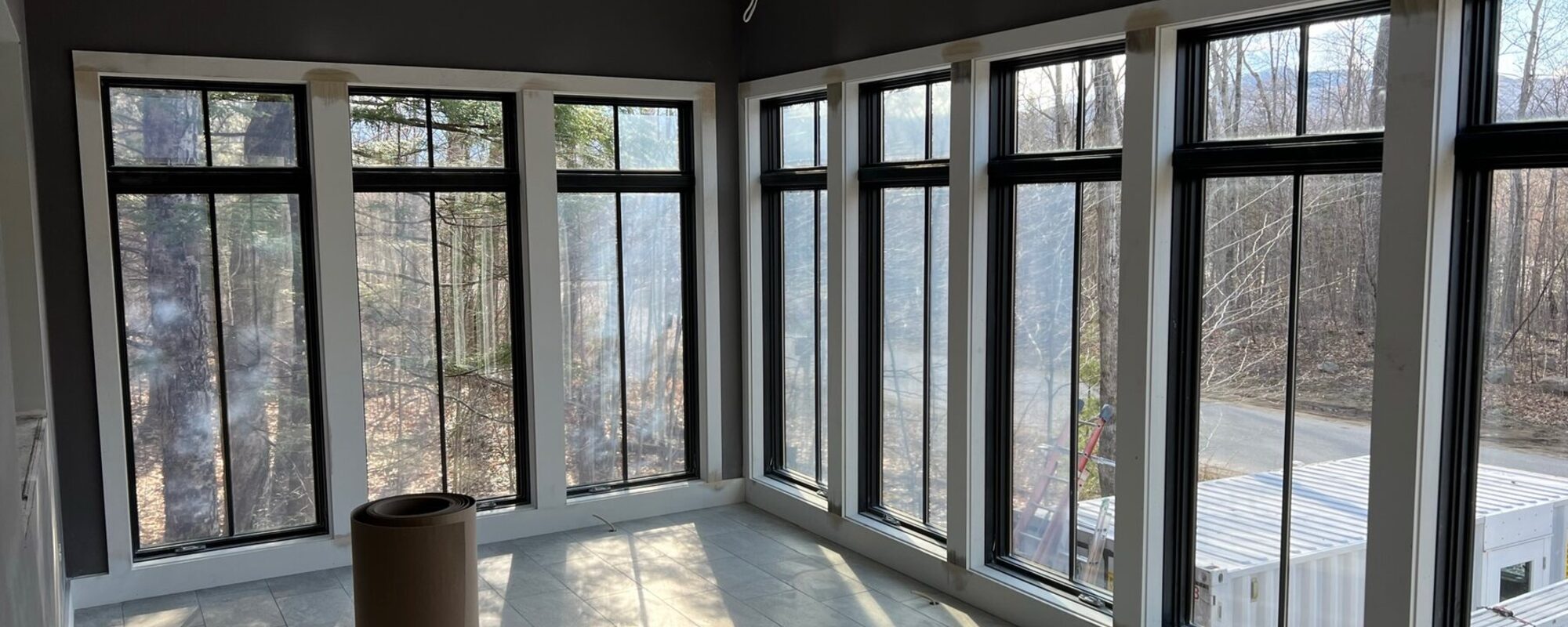 Sunroom framed with black windows and clean interior trim