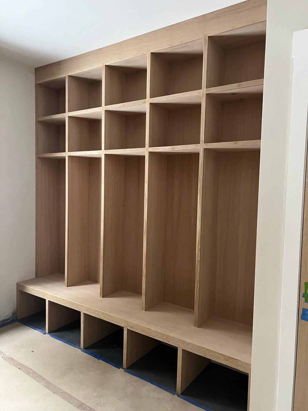 Mudroom lockers built in raw wood before finishing