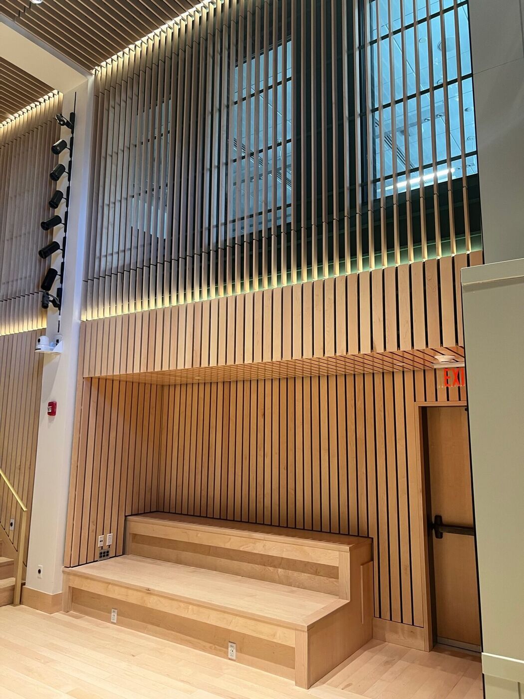 Slat wall paneling with a floating bench and hidden lighting